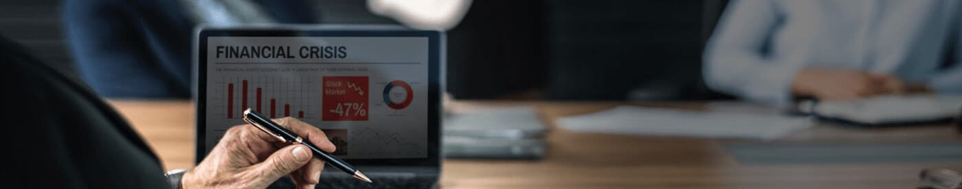 Business people at conference room table with laptop screen showing a financial dashboard with the title of financial crisis.